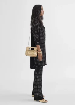 Top largo con piezas metalicas